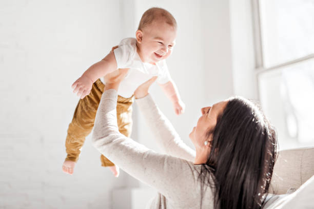 istock Mother with a baby on bed at home 1078557244