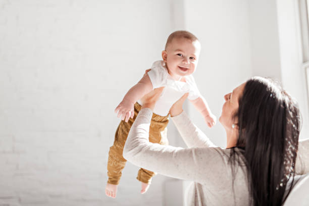 istock Mother with a baby on bed at home 1078557288