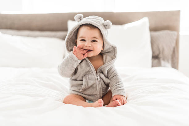 Portrait of a baby boy on the bed in bedroom stock photo