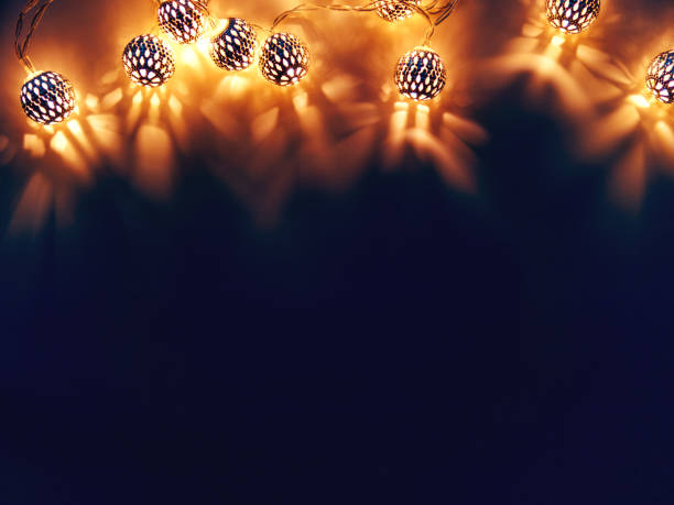 istock Dark background with light bulbs. Metal light bulbs with delicate pattern. Holiday background with place for text. 1078560326