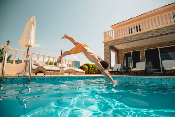 istock Young Man Diving into the Swimming Pool 1078562930