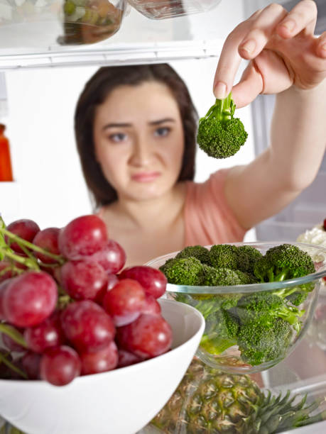 istock Woman taking vegetables from a fridge 1078562992