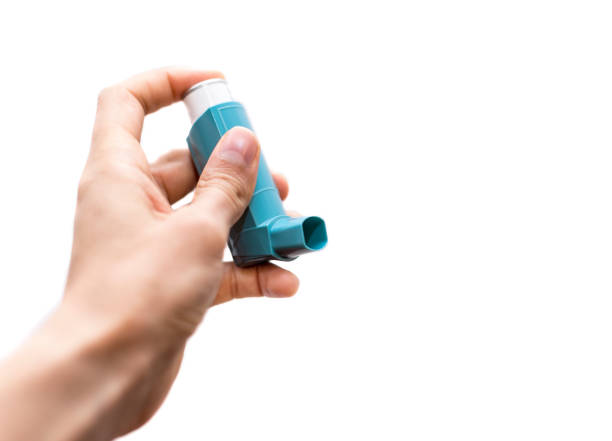 istock Caucasian man with asthma spray in hand over the white isolated background. 1078567766