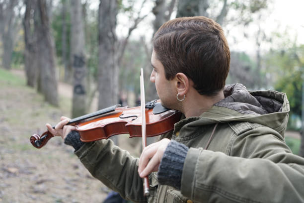 istock The man playing the violin on the beach 1078569498