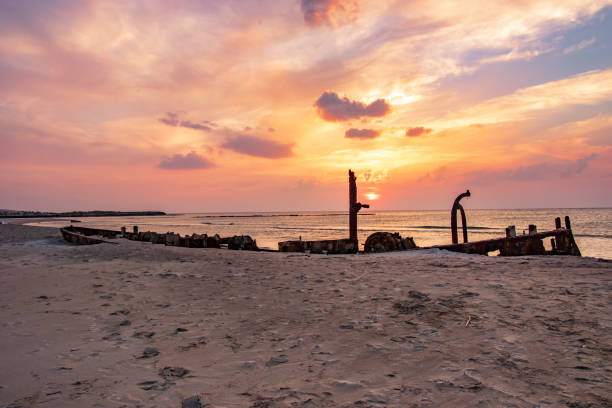 istock A ship sunk on the beach at sunset 1078571440