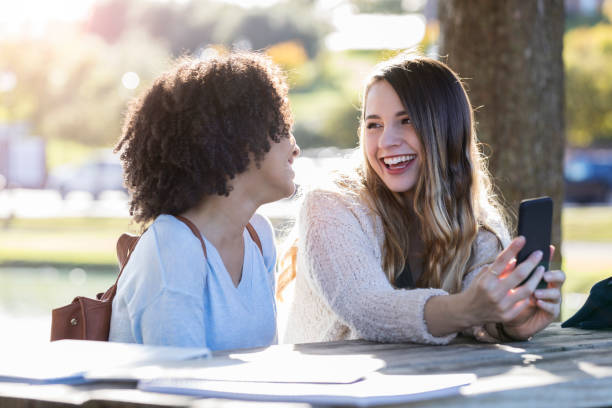 istock Two female college friends study outdoors together 1078571550