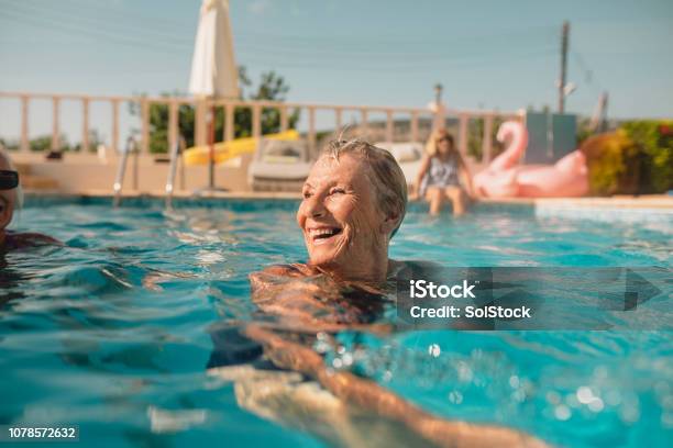 Senior Woman Enjoying Summer Vacation Stock Photo - Download Image Now - Senior Adult, Swimming Pool, Swimming