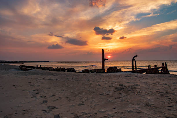 istock A ship sunk on the beach at sunset 1078575684