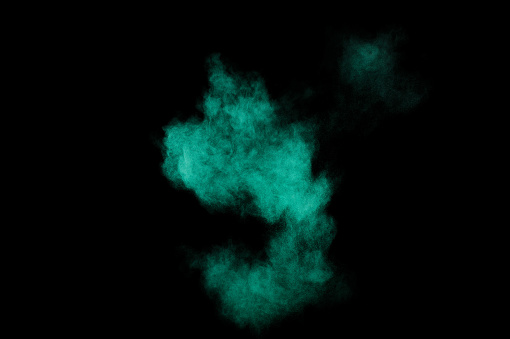 Aquamarine powder explosion on black background. Colored powder cloud. Colorful dust explode. Paint  Holi.