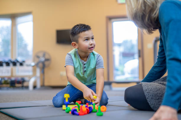 istock Occupational therapist works with a young ethnic boy 1078576000
