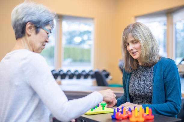 istock Occupational therapist works with an elderly woman 1078576008