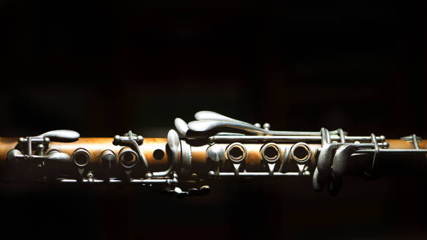 istock Ancient clarinet. Detail on a black background 1078581202
