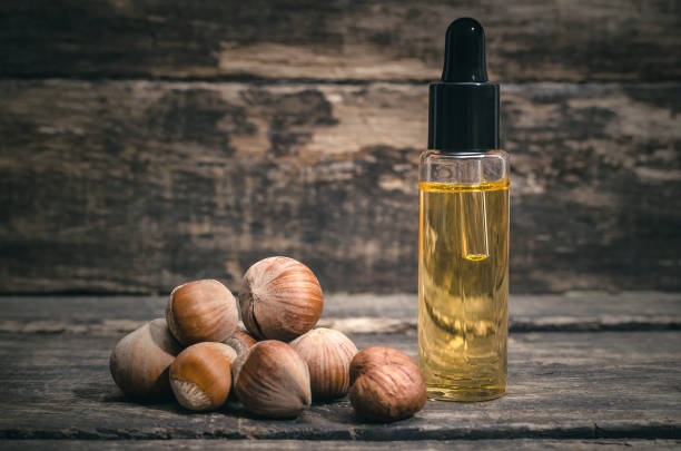 Nut oil. Hazelnut nut oil in the bottle on the wooden table background. hazel tree stock pictures, royalty-free photos & images