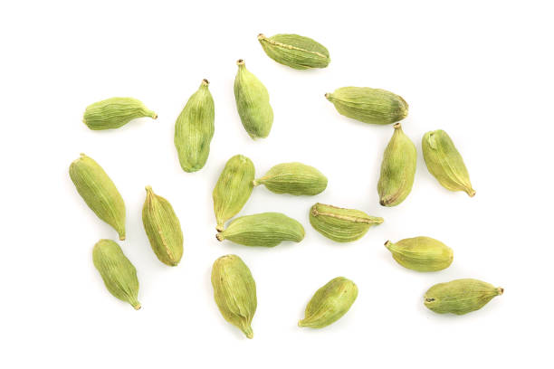 Green cardamom seeds isolated on white background. Top view. Flat lay.