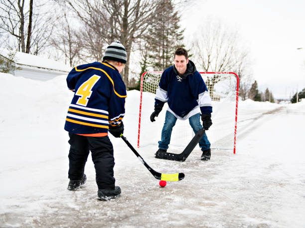 istock A Father and son have fun playing hockey 1078587380