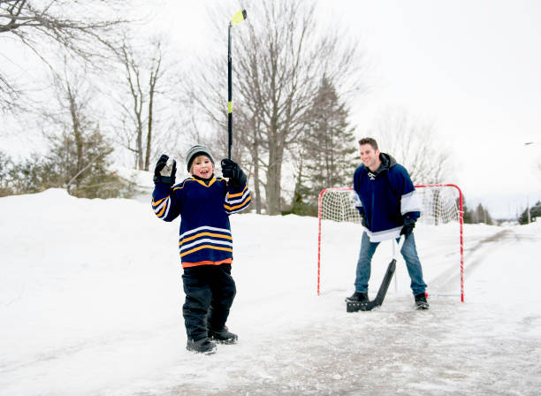 istock A Father and son have fun playing hockey 1078587390