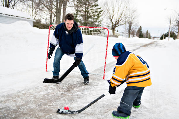 istock A Father and son have fun playing hockey 1078587402