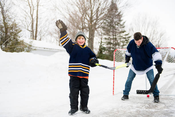 istock A Father and son have fun playing hockey 1078587410