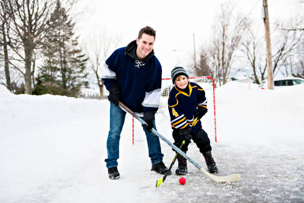 istock A nice Father and son playing hockey 1078587436