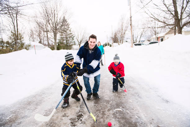 istock A nice Father and two sons playing hockey 1078587446