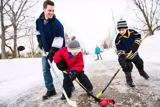 istock A nice Father and two sons playing hockey 1078587458