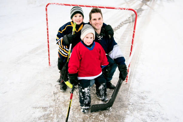 istock Father and son have fun playing hockey 1078587500