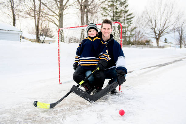 istock A Father and son have fun playing hockey 1078587538