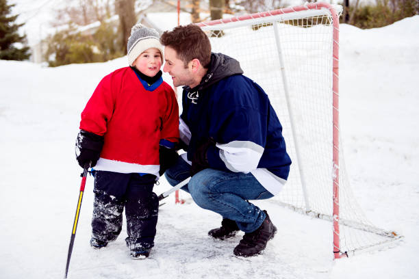 istock A Father and son have fun playing hockey 1078587584