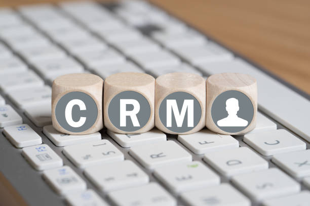 cubes with letters forming the acronym CRM on a keyboard