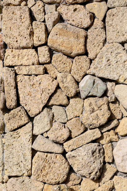 the brown texture of the masonry. background the brown texture of the masonry stone wall stone wall crag stock pictures, royalty-free photos & images