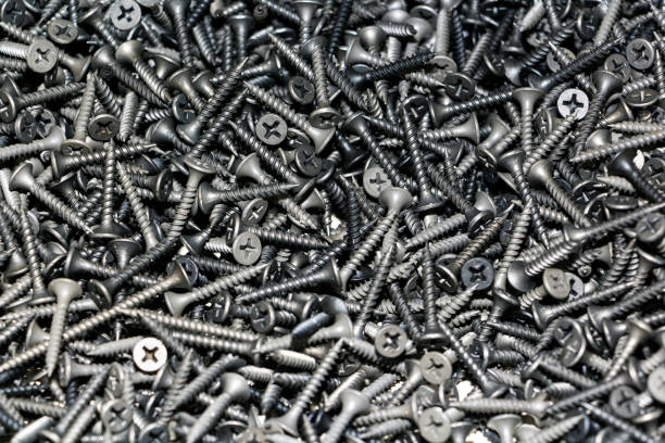 istock focus on center. black screws texture background closeup, modern metal mix diversity 1078591302