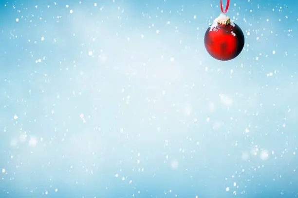 Christmas background with red ornament and falling snow