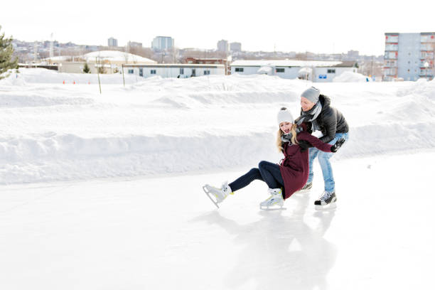 istock couple in sunny winter nature ice skating 1078594830