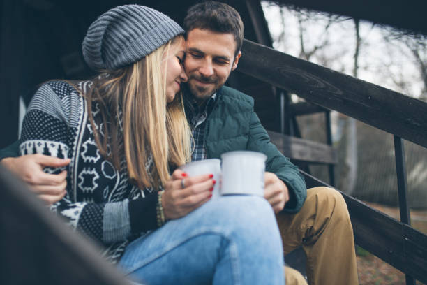 istock Happy couple drinking hot tea outdoor on cozy camping 1078611900