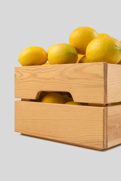 istock Fresh lemons in a wooden crate 1078620702