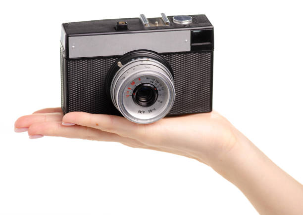 istock Old photo camera in hand 1078633976