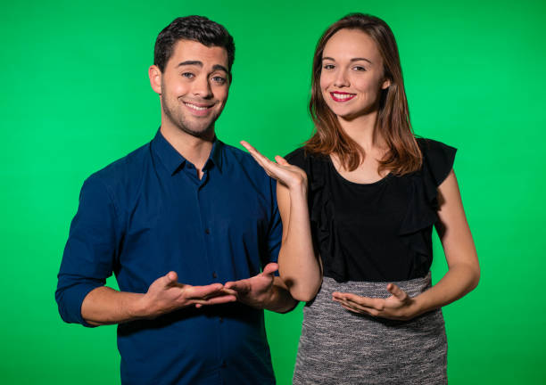 Beautiful, young couple in front of a greenscreen background. stock photo