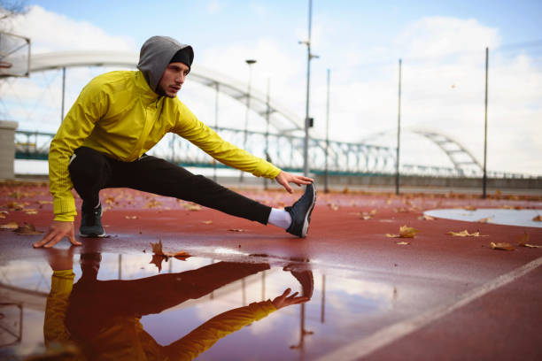 istock Young athlete man stretching his muscles before running outdoors 1078637446