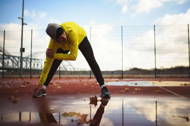istock Young athlete man stretching his muscles before exercise 1078637828