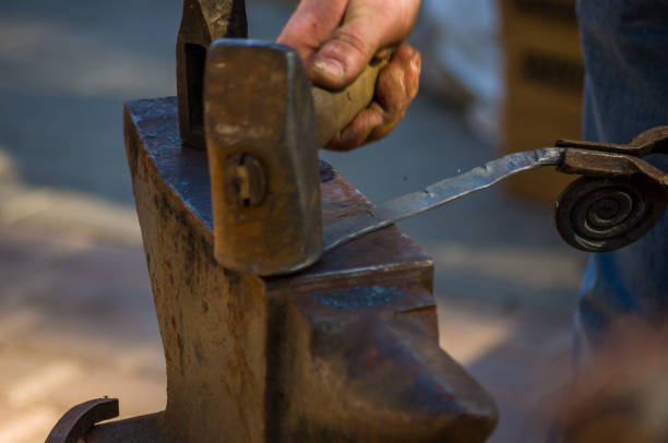 istock blacksmith performs the forging of hot glowing metal on the anvil 1078645668