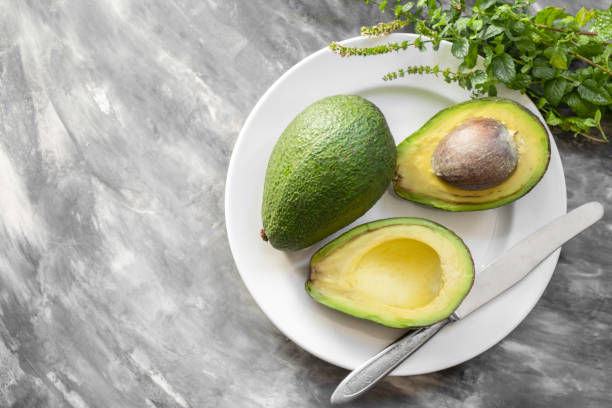istock Avocado in the white plate on a gray background 1078645684