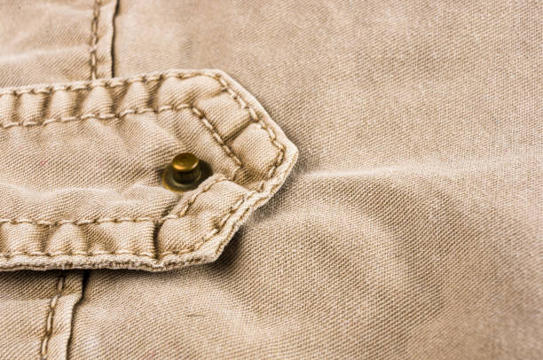 istock clothing items washed cotton fabric texture with seams, clasps, buttons and rivets 1078652926