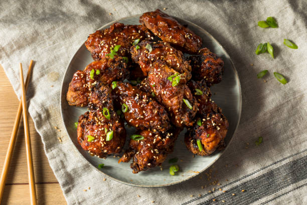 Homemade Spicy Korean Chicken Wings Homemade Spicy Korean Chicken Wings with Sesame Seeds korea stock pictures, royalty-free photos & images