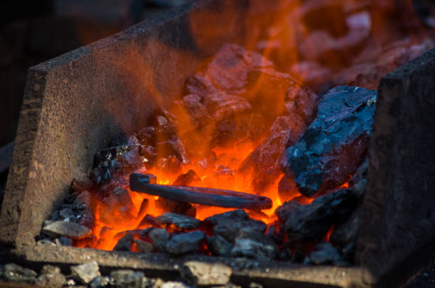istock blacksmith furnace with burning coals, tools, and glowing hot horseshoe 1078657742