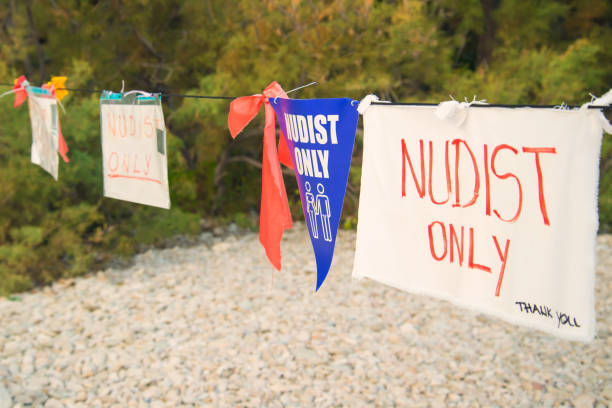 nudists only hand made sign on beach hand made notice on Nugal beach saying that only nudists can be in that part of the beach, Croatia nude coloured stock pictures, royalty-free photos & images