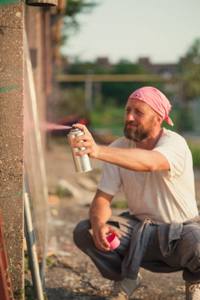 istock young man spray paint artist 1078688960