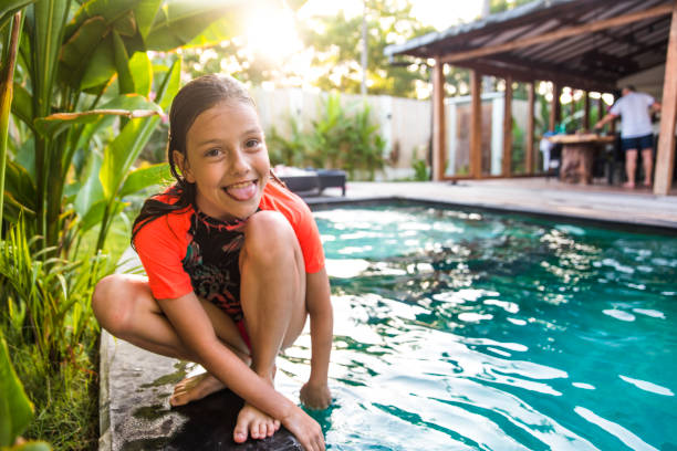 Cute girl by the swimming pool Cute girl sticking her tongue out by the swimming pool. gili trawangan stock pictures, royalty-free photos & images