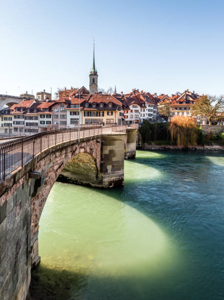 View of Bern old town over the Aare river, Switzerland View of Bern old town over the Aare river, houses, bridge and church in the winter, Switzerland bern photos stock pictures, royalty-free photos & images