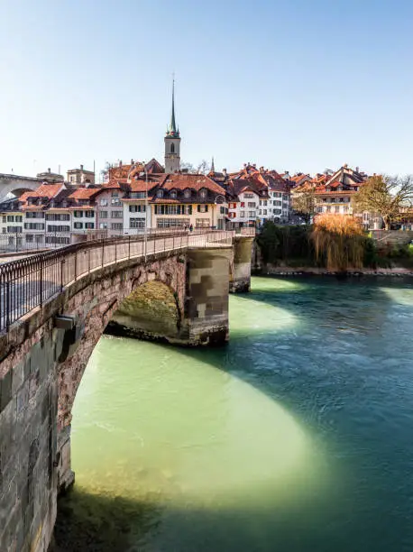 View of Bern old town over the Aare river, houses, bridge and church in the winter, Switzerland