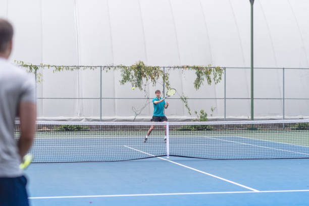 istock Two males playing outdoor tennis 1078703478